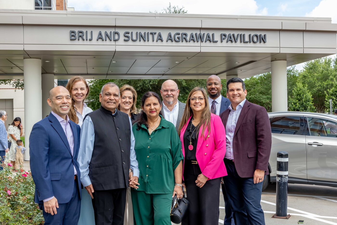 Brij and Sunita Agrawal with Houston Methodist Sugar Land leaders beneath the Brij and Sunita Agrawal Pavilion sign