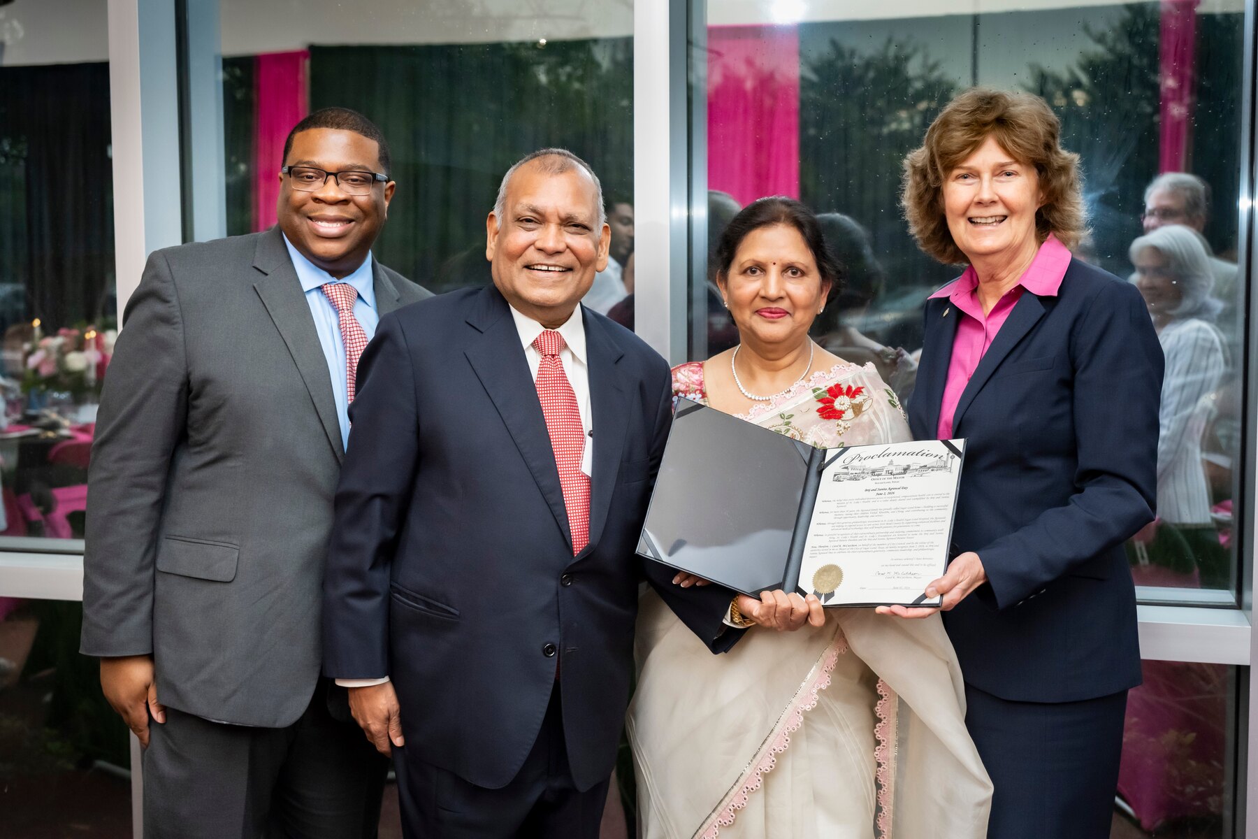 Brij and Sunita Agrawal receiving a City of Sugar Land proclamation with local representatives at St. Luke's Health-Sugar Land